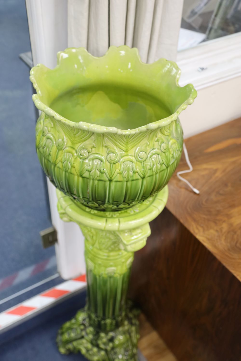 An apple green-glazed majolica jardiniere on matching stand with acanthus and other foliate moulding